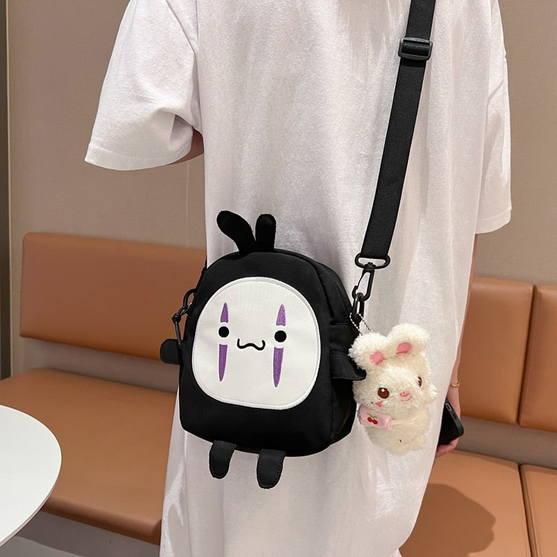 Cute Cartoon No Face Man Plush Bag Hayao Miyazaki Messenger Bag for Kids Adults - TIKIJTRONICS 0 SPECIFICATIONSWarning: -Recommend Age: 12+y,18+Origin: Mainland ChinaModel Number: faceless men's plush bagMaterial: PlushItem Type: Plush BackpacksGender: GirlsFeatures: Stuffed & PlushDimensions: About 19 x 20 x 7cmBrand Name: Sevrwell TIKIJTRONICS  (Store description)